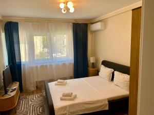 a bedroom with a bed with two towels on it at Constanta Seaside Studio in Constanţa