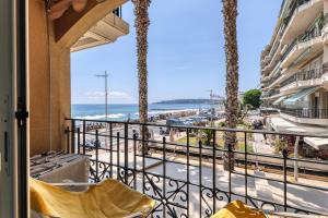 a balcony with a view of the beach at Victoria Beach Apartments in Menton +64 photos