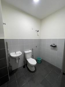 a bathroom with a toilet and a sink at D'Haira Homestay Port Dickson Mu5lim Only in Port Dickson