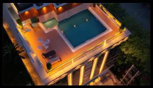 an overhead view of a swimming pool at night at The Shining Sun in Jorhāt
