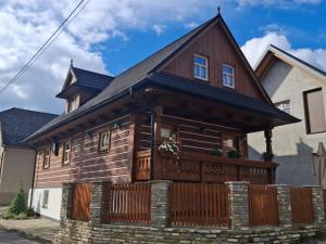 a log home with a fence at Chalet Maria Lendak in Lendak