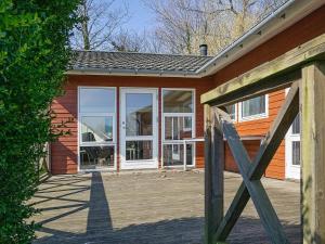 a house with a wooden porch with a wooden gate at 4 star holiday home in Allinge in Allinge