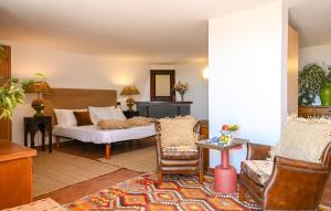 a living room with a bed and chairs at Gorgeous Home In Strettoia in Strettoia