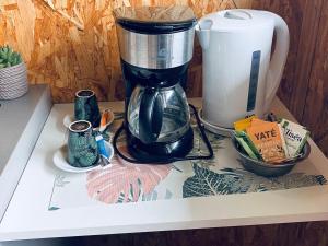 a coffee maker sitting on top of a counter at Gîte Le Prunier à Le Tampon - FR-1-786-65 in Maison de lʼEnfance