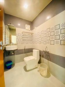 a bathroom with a toilet and a sink at Casa Nube Resort Munnar in Munnar +36 photos