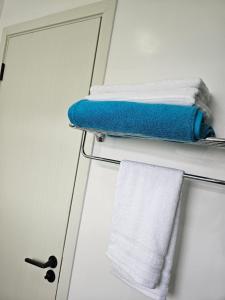 a towel hanging on a towel rack next to a door at Serenity stay Kilimani in Nairobi