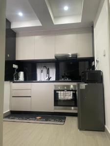 a kitchen with a black and white stove top oven at Serenity stay Kilimani in Nairobi