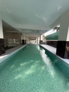 a swimming pool with green water in a building at Serenity stay Kilimani in Nairobi