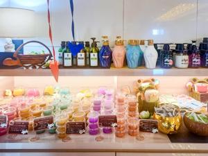 a shelf filled with lots of different colored vases at Hotel BaliBali 岩槻 in Saitama