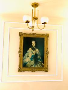 a painting of a woman hanging on a wall at Résidence touristique marcadal in Fort de lʼEau