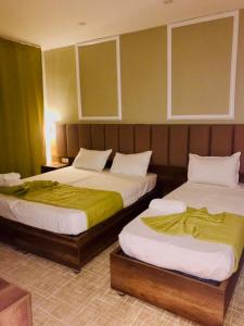 two beds sitting next to each other in a room at Résidence touristique marcadal in Fort de lʼEau +13 photos