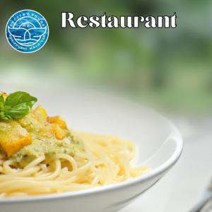 a white plate of pasta with a garnishment at All Inclusive Stays by Excited Tours - Dhiffushi in Dhiffushi