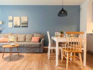 a living room with a couch and a table and chairs at Old Town Walowa in Gdańsk