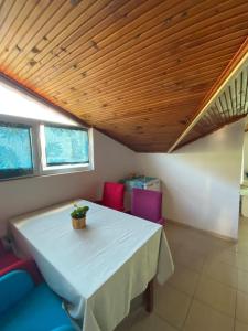 a table and chairs in a room with a wooden ceiling at Deka apartments 7 in Fethiye
