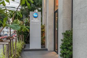 un cartello con la scritta "miglior museo" di fronte a un edificio di Best Western Ratchada Hotel a Bangkok