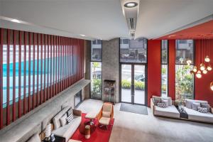 a living room with a pool in the background at Best Western Ratchada Hotel in Bangkok