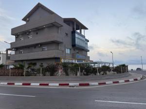a building sitting on the side of a road at Résidence touristique les jasmins الياسمين in Les Sablettes Mazagran-Plage +13 photos