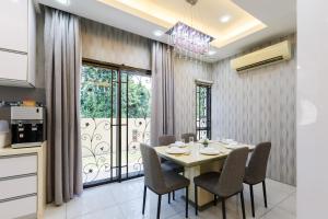 a dining room with a table and chairs and a window at Comfy Bungalow Family House Pg Hill & Kek Lok Si in Ayer Itam