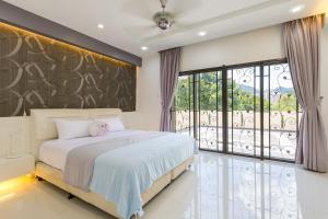 a bedroom with a bed and a large window at Comfy Bungalow Family House Pg Hill & Kek Lok Si in Ayer Itam +80 photos