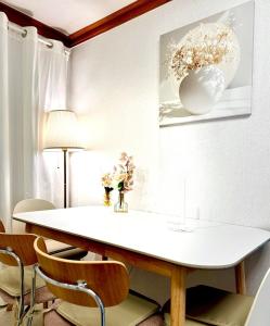 a dining room with a white table and chairs at Seoul Gate Stay in Seoul