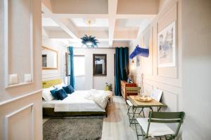 a bedroom with a bed and a table and chairs at Blue Camel in Old Town in Bucharest