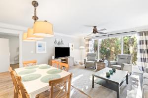 a living room with a table and a dining room at Lagoon Villa 43 - Close to Ocean! Easy Access to Resort! in Isle of Palms