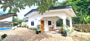 a villa with a swimming pool at a resort at Casa Feliz Ocean Resort in Siquijor