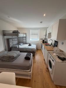 a room with two bunk beds and a kitchen at Keysan House 1 in London +140 photos