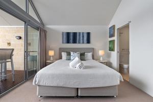 a bedroom with a large white bed and a balcony at Haven on Seine - Luxury 3Brm Apartment in Augusta