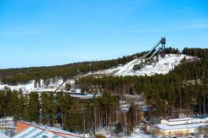 a ski lift on top of a snow covered mountain at Scandic Lugnet in Falun