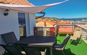 a table and chairs on the balcony of a house at Awesome Apartment In Tkon With House Sea View in Tkon