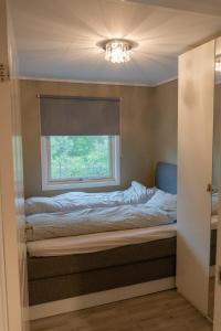 a bed in a room with a window at Delicate apartment with magical views in Tromsø