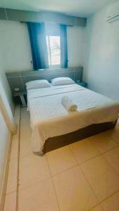 a bedroom with a large bed with blue curtains at SET INN restaurant & bar in Kata Beach