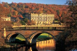 a bridge over a river in front of a large building at Barn Conversion - Sleeps 4 - Pet friendly - Garden in Whiston