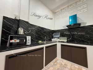 una cocina con encimera en blanco y negro en O Pha Suk House, en Hat Yai