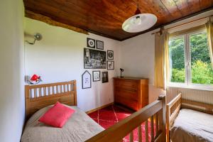 a bedroom with a bed and a wooden ceiling at Blue cottage in Normandie in Ouville-lʼAbbaye