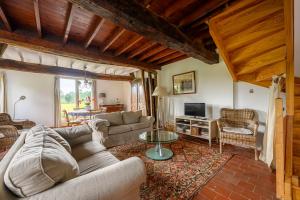 a living room with a couch and a table at Blue cottage in Normandie in Ouville-lʼAbbaye