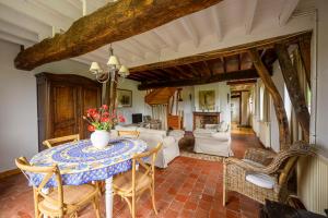 a dining room with a table and chairs at Blue cottage in Normandie in Ouville-lʼAbbaye