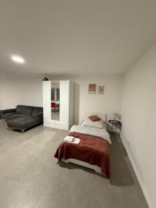 a bedroom with a bed and a couch at Apartment Natalie in Hagen