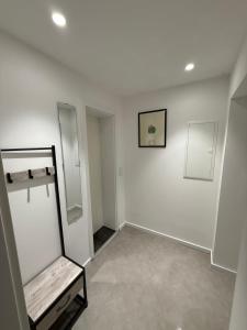 a white room with a mirror and a shelf at Apartment Natalie in Hagen