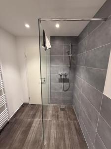 a shower with a glass door in a bathroom at Apartment Natalie in Hagen