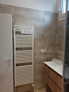 a bathroom with a white sink and a shower at Cá del Manöl in Villa di Tirano