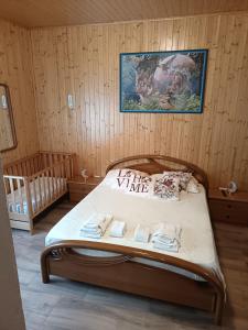 a bedroom with a bed with a poster on the wall at Cá del Manöl in Villa di Tirano