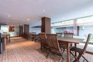 a dining room with wooden tables and chairs at Sans Vibes Residence and Villa Cemagi in Cemagi