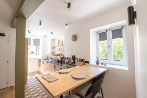 a kitchen with a wooden table and chairs at Hôtel De L'Ill in Strasbourg