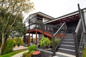 a house with a glass roof and stairs at Kiwi Retreat By Aotearoa Escapes in Ngongotaha