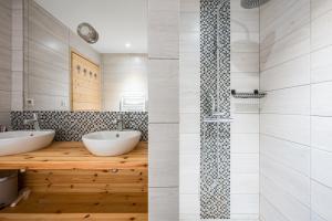 two views of a bathroom with two sinks and a shower at Lune des Alpes - Chalet de charme in Valloire