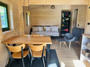 a room with a table and chairs and a couch at Zelenka in Malenitz