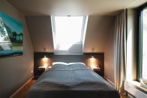 a bedroom with a large bed with two windows at Ferienhaus Siegfried in Dierhagen