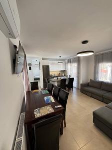 a kitchen and living room with a table and a couch at Panorama Apartment in Kavála